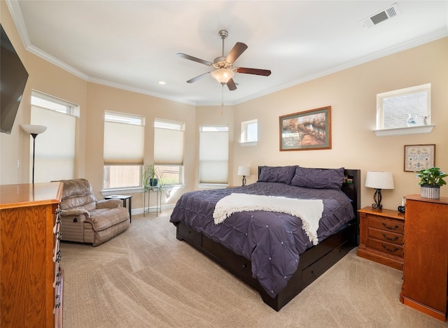 bedroom featuring crown molding, light colored carpet, and ceiling fan