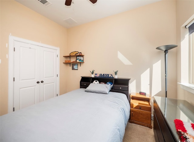 bedroom with light carpet, a closet, and ceiling fan