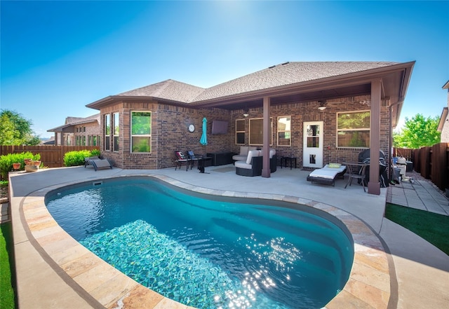 view of swimming pool with an outdoor living space, a patio area, and ceiling fan