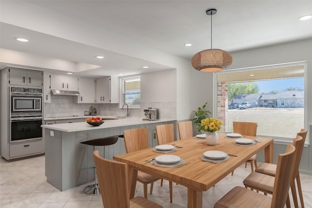 dining room with sink and light tile patterned flooring