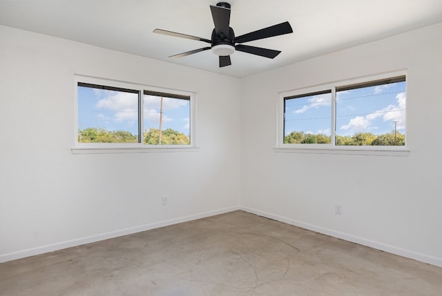 unfurnished room featuring ceiling fan and plenty of natural light