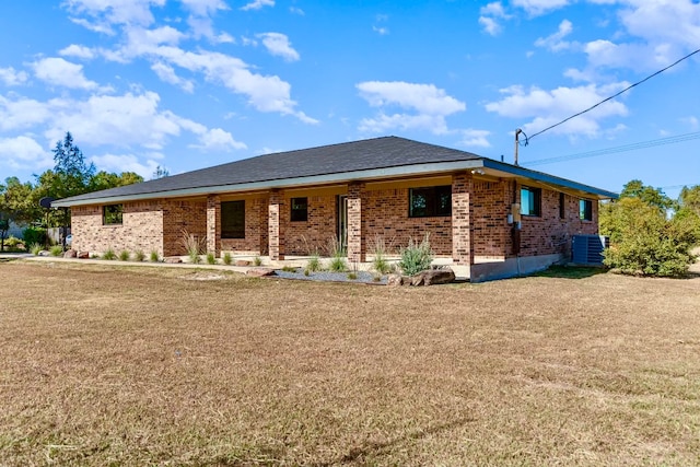 exterior space with central AC and a lawn