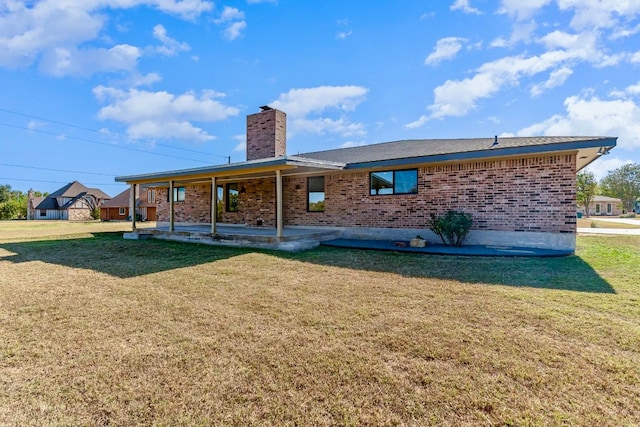 rear view of property with a lawn