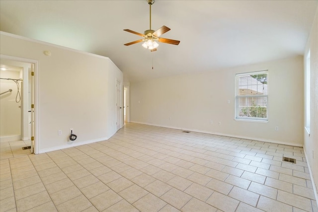 tiled empty room featuring ceiling fan and lofted ceiling