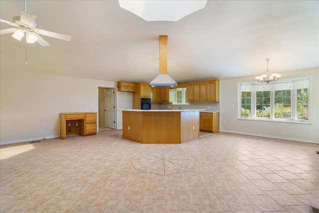 kitchen with a center island, oven, ceiling fan with notable chandelier, hanging light fixtures, and a skylight