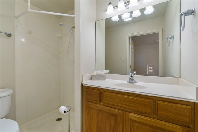 bathroom featuring walk in shower, vanity, and toilet