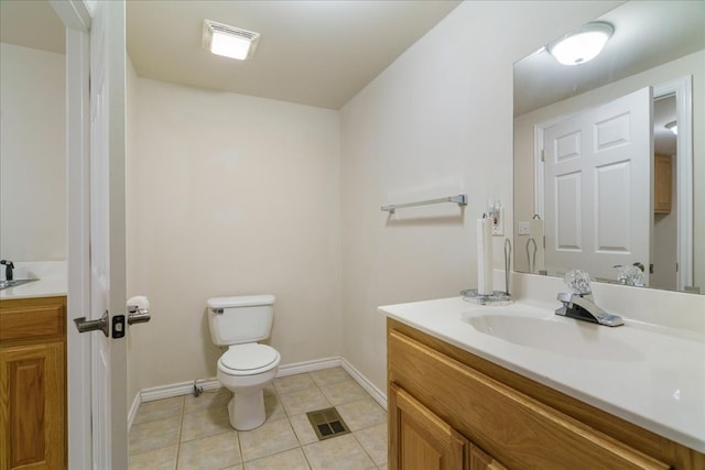 bathroom featuring tile patterned floors, vanity, and toilet