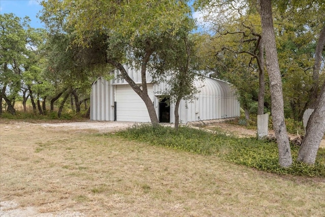 exterior space with a front yard and an outbuilding