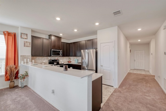 kitchen featuring light carpet, visible vents, appliances with stainless steel finishes, and dark brown cabinets