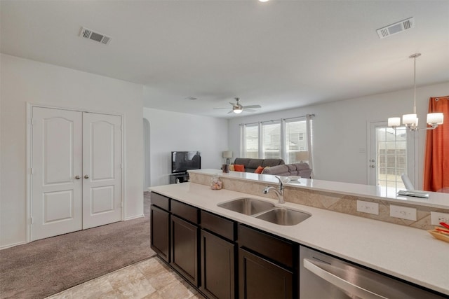 kitchen with dishwasher, light countertops, a sink, and visible vents