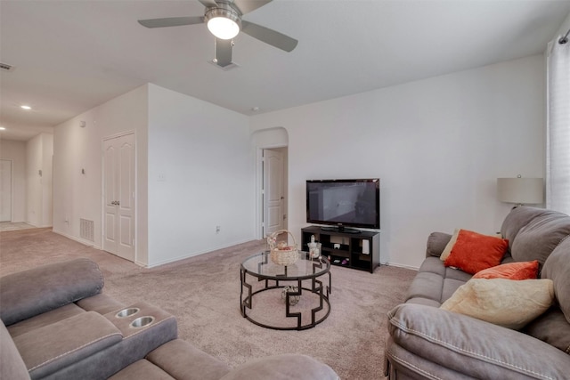 living room featuring visible vents, baseboards, and light colored carpet