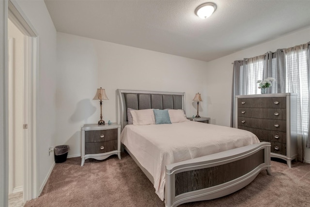 bedroom featuring baseboards and carpet flooring