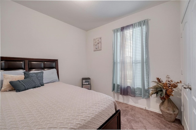 carpeted bedroom featuring baseboards