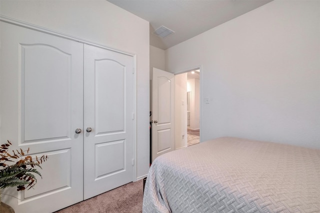 bedroom featuring light carpet, a closet, and visible vents