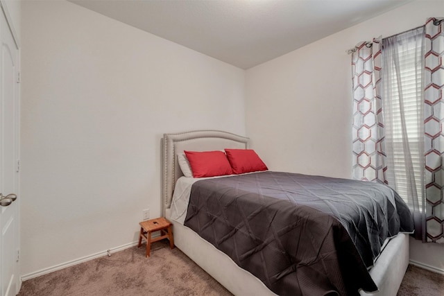 bedroom with carpet floors and baseboards