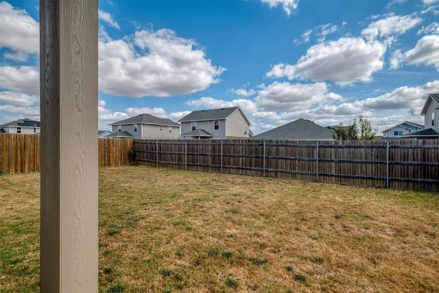 view of yard with a fenced backyard and a residential view