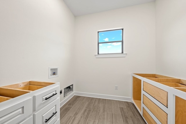 clothes washing area featuring light hardwood / wood-style flooring and hookup for a washing machine