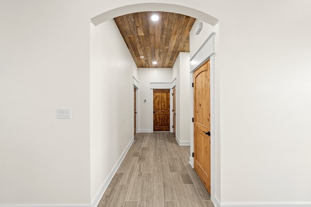 corridor featuring wood ceiling and light wood-type flooring