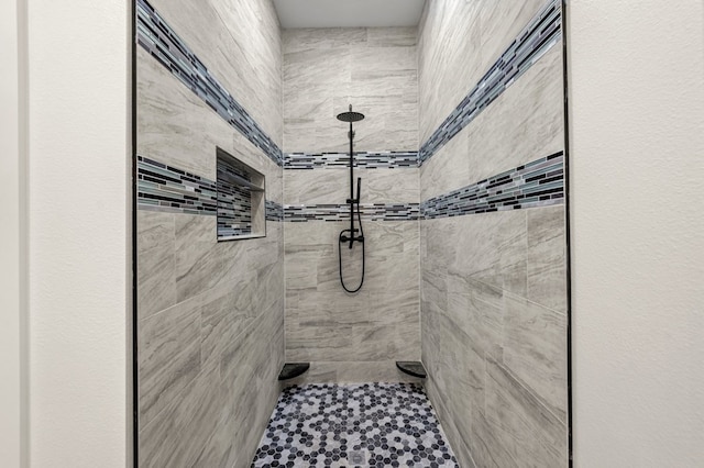 bathroom with a tile shower