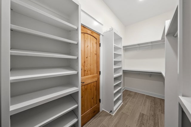 walk in closet featuring hardwood / wood-style floors