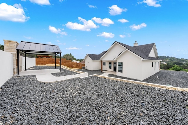 rear view of property with a gazebo and a patio