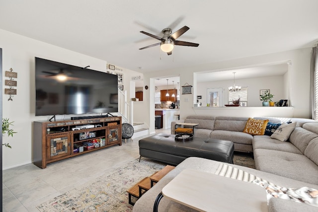 tiled living room featuring ceiling fan with notable chandelier