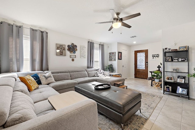 living room with ceiling fan, light tile patterned flooring, and a wealth of natural light