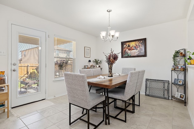 dining space featuring a notable chandelier and light tile patterned floors