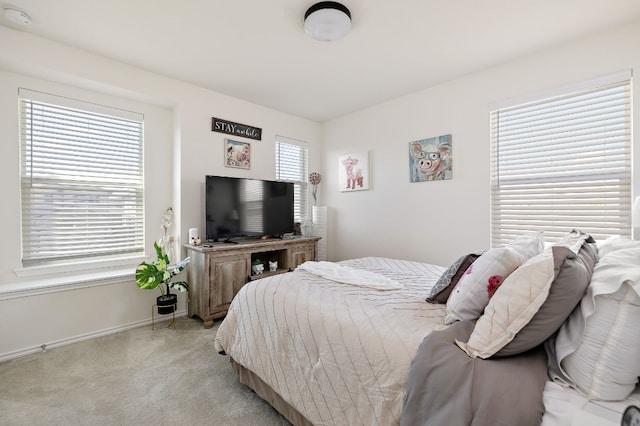 carpeted bedroom with multiple windows