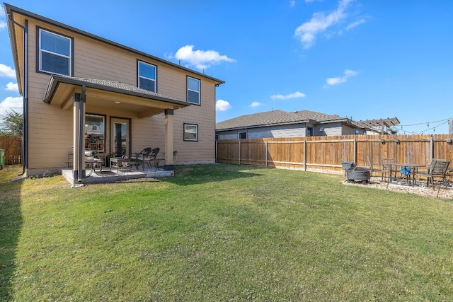 rear view of property with a patio and a lawn