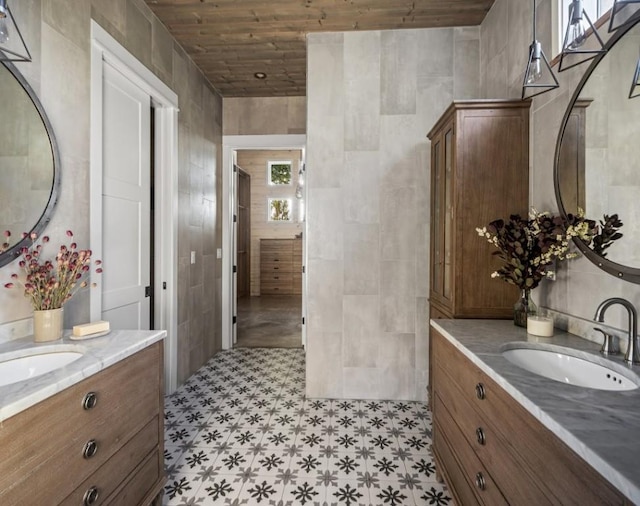 306 Fire Dance, Horseshoe Bay, TX 78657 - bathroom with tile patterned floors, two vanities, wood ceiling, and tile walls
