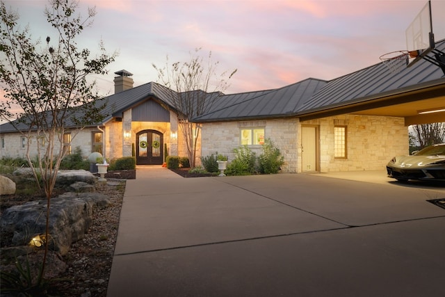 view of front of home featuring french doors and a carport