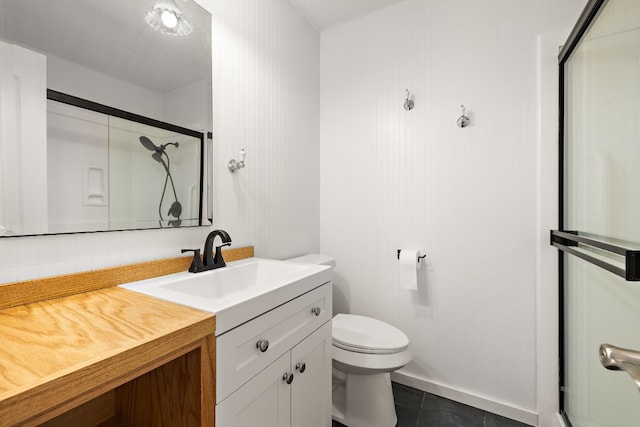 bathroom featuring tile patterned floors, vanity, toilet, and a shower with shower door