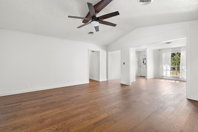 empty room featuring ceiling fan, dark hardwood / wood-style floors, a textured ceiling, and vaulted ceiling