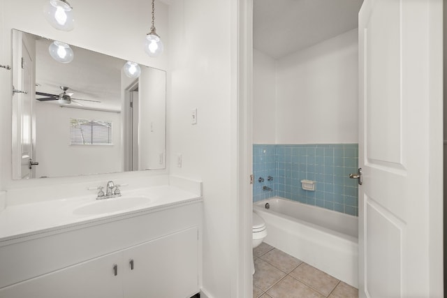 bathroom featuring vanity, tile patterned floors, ceiling fan, toilet, and a tub