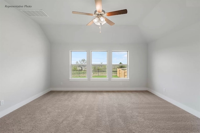 carpeted empty room featuring ceiling fan and lofted ceiling