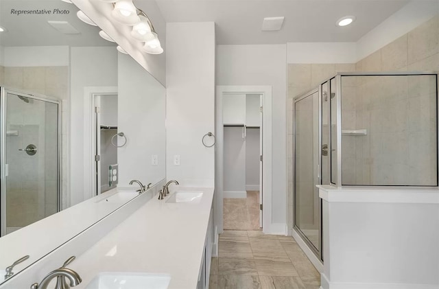 bathroom with vanity, walk in shower, and tile patterned flooring