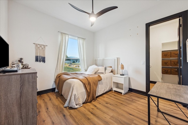 bedroom with light hardwood / wood-style flooring and ceiling fan