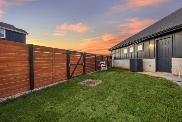 yard at dusk with central AC