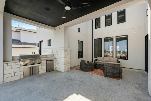 view of patio / terrace with an outdoor kitchen, ceiling fan, an outdoor hangout area, and grilling area