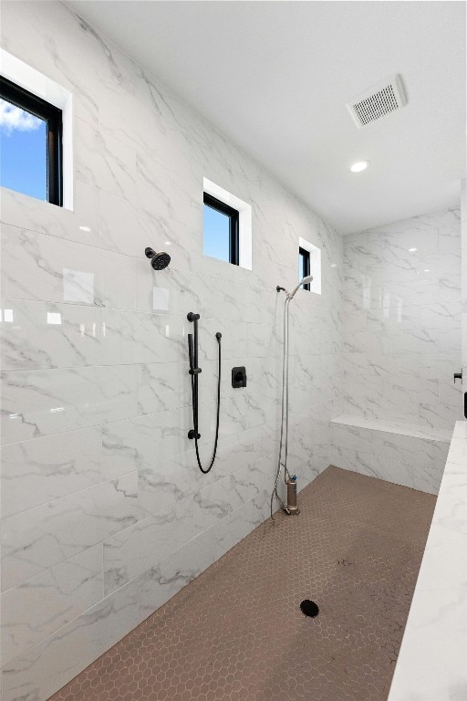 bathroom with tiled shower