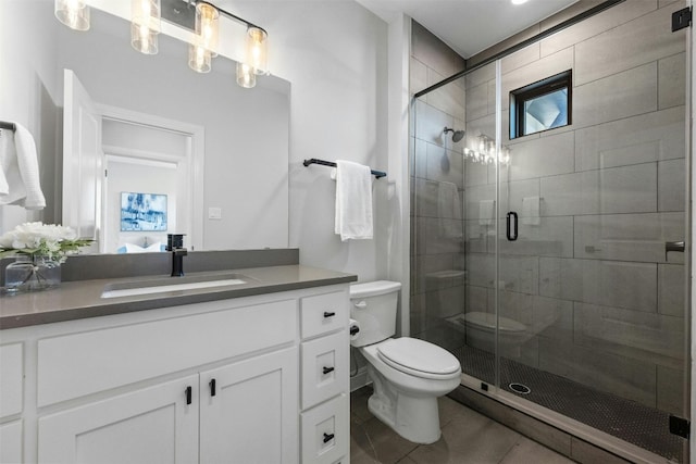 bathroom featuring tile patterned floors, vanity, toilet, and walk in shower