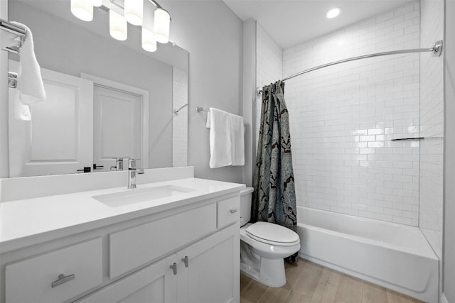 full bathroom with wood-type flooring, vanity, toilet, and shower / bathtub combination with curtain