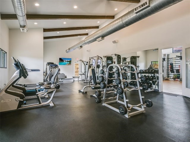 exercise room with a high ceiling