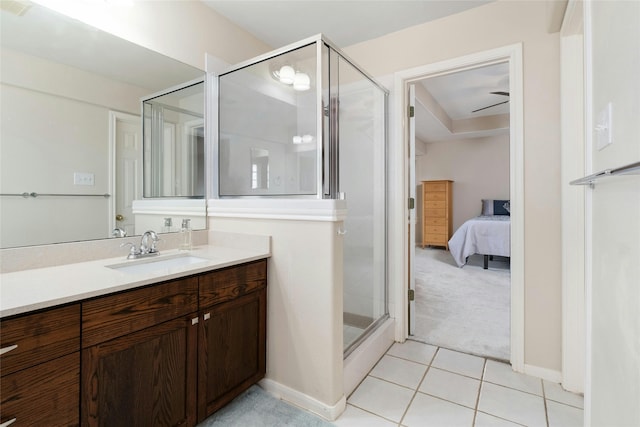 bathroom featuring ceiling fan, vanity, tile patterned flooring, and walk in shower