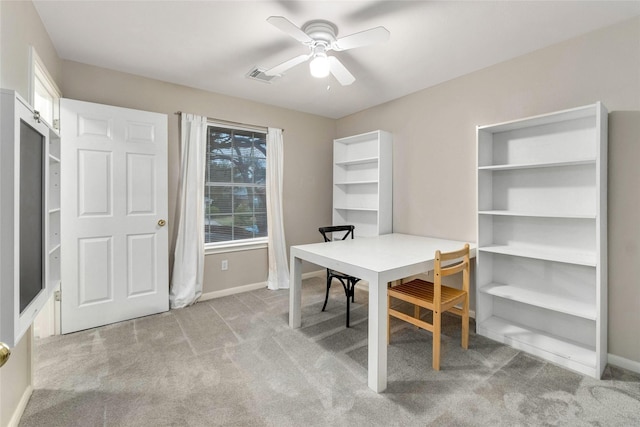 carpeted dining space featuring ceiling fan