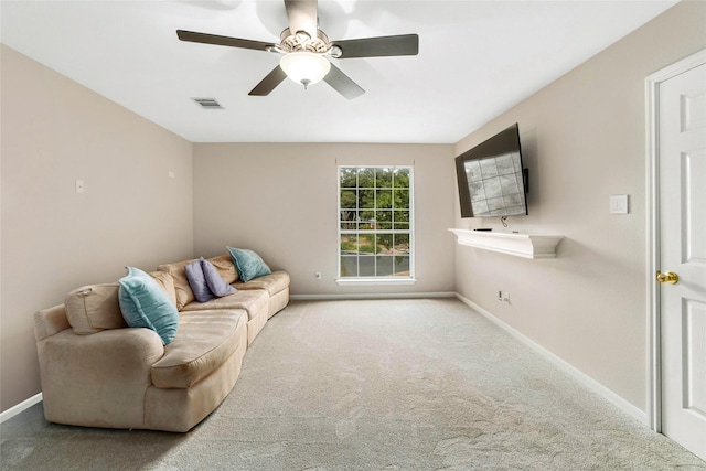 living room with ceiling fan and light colored carpet