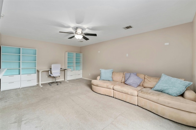 carpeted living room with ceiling fan