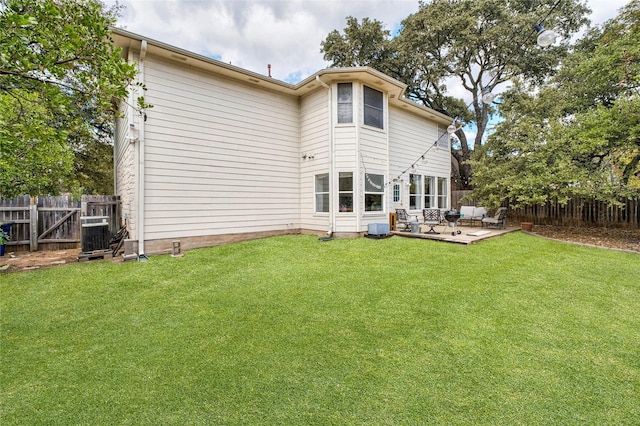 back of house with central air condition unit, a yard, and a patio