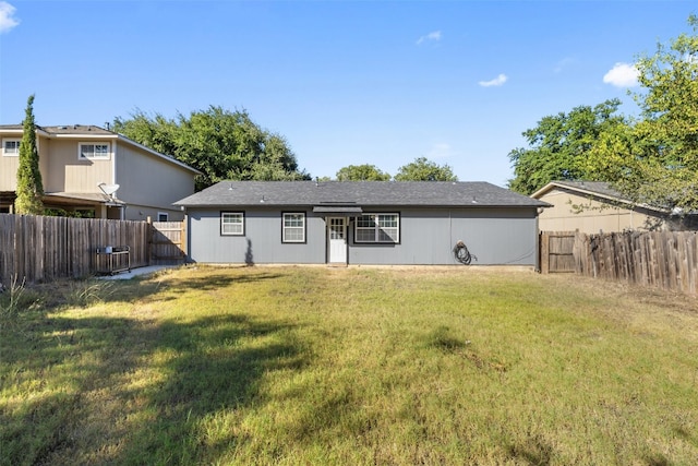 back of property featuring a yard